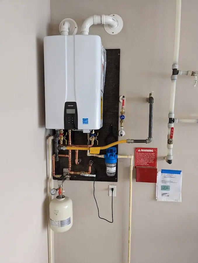 Professional plumber installing copper piping in a Leawood home